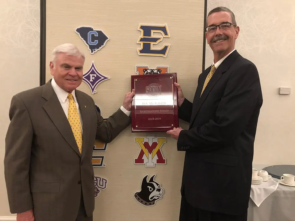 en. J.H. Binford Peay III ’62 and Dr. David Diles posing with SoCon award plaque.