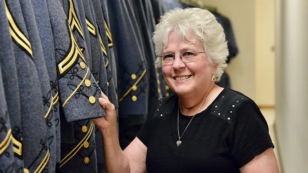 woman posing with coatee jacket, smiling