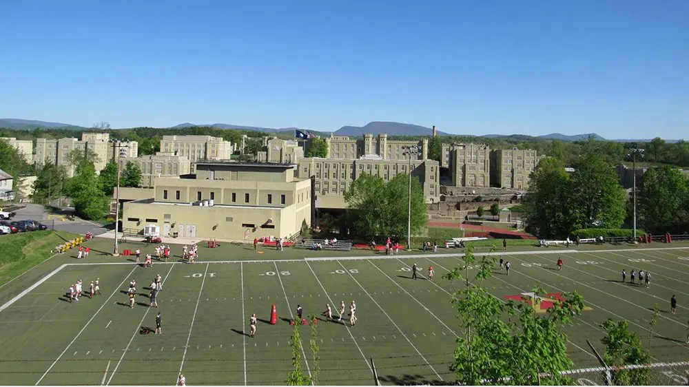Football players gathering on Alumni Memorial Field.