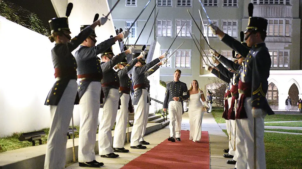 Cadets and their dates pass through a saber cordon before entering the Ring Figure ball in Cocke Hall.