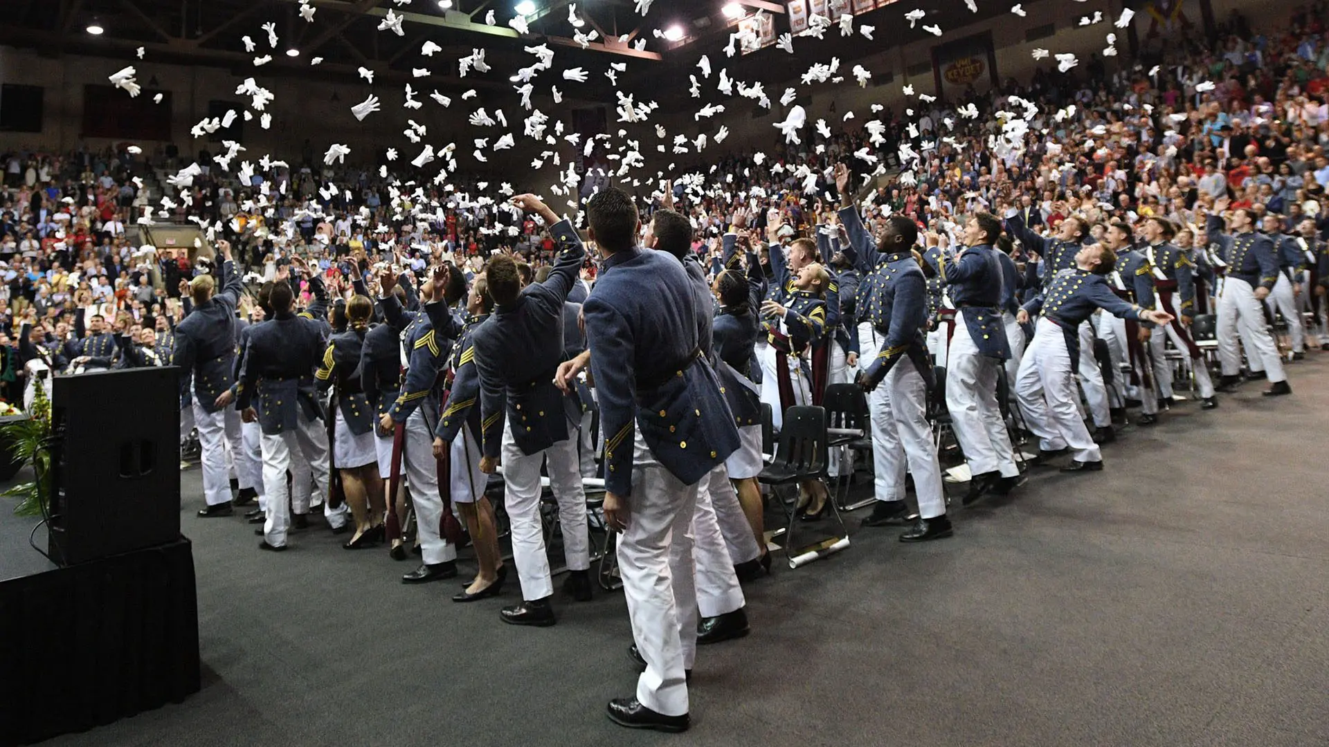 cadets throwing gloves at graduation