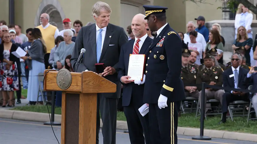 three people standing in front of a podium