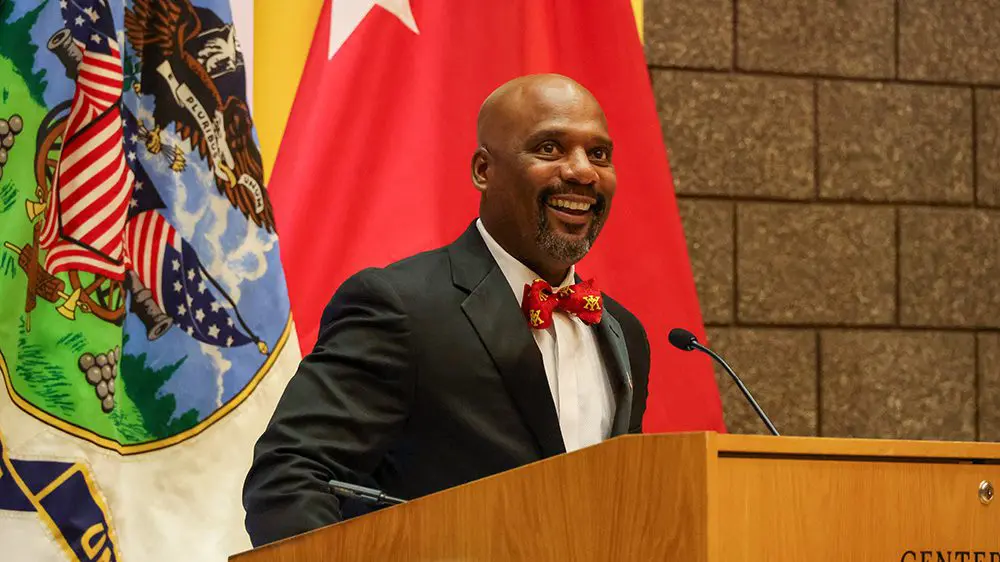 Ernesto Sampson smiling at podium