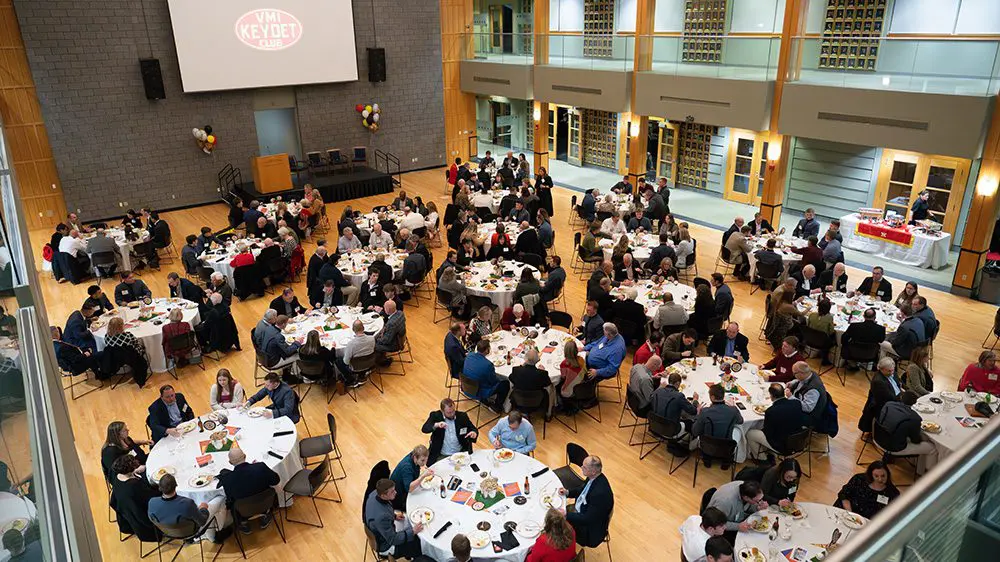 overhead shot of people seated at large round tables in the CLE