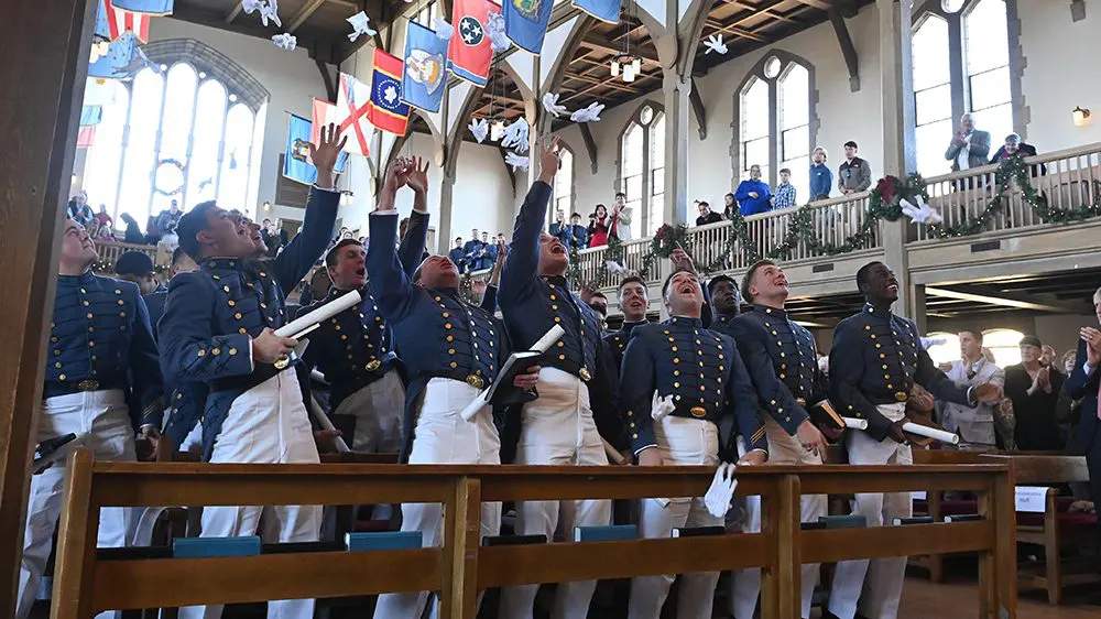 cadets throwing gloves in the air