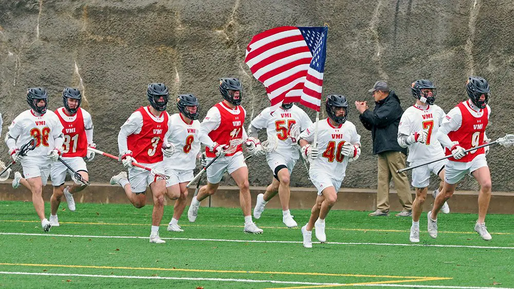 lacrosse team running with American flag