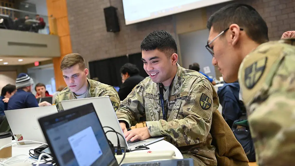 cadets working on laptops