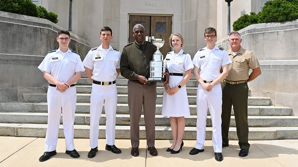 Maj. Gen Wins holding trophy and smiling with group of cadets