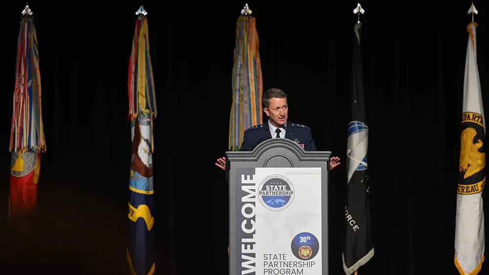 U.S. Air Force Lt. Gen. Dan Caine ’90 speaking behind a podium