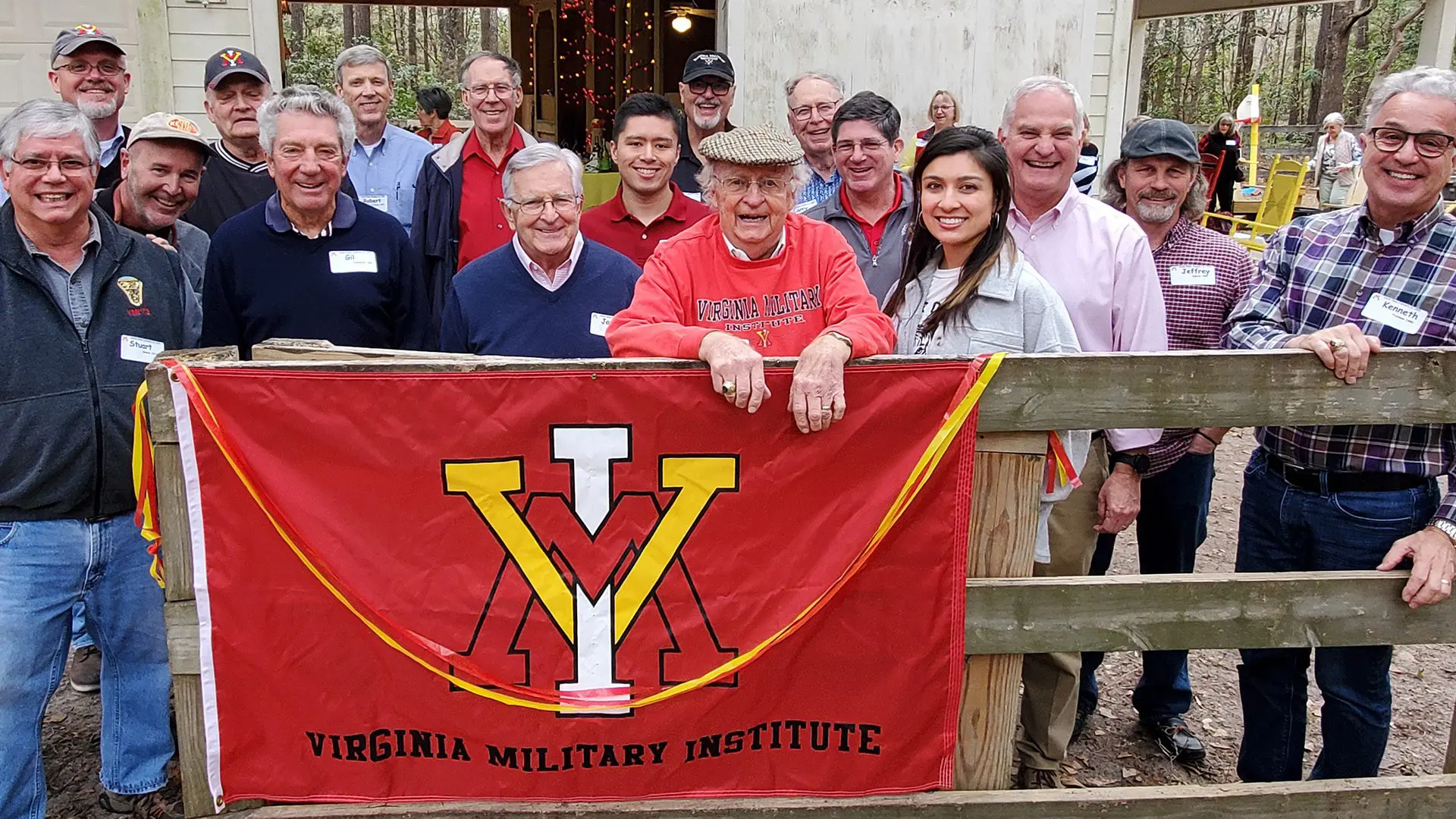 A group of alumni holding a vmi flag