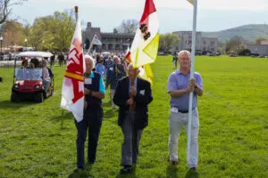 Tom Altizer ’49B, James “Ding” Patton ’49B, and Joe Haggerty (HBR ’49B) carry the Class of 1949B flag into barracks for Old Yells.