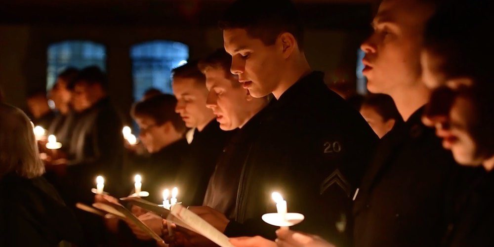 Cadets singing with candles at holiday event