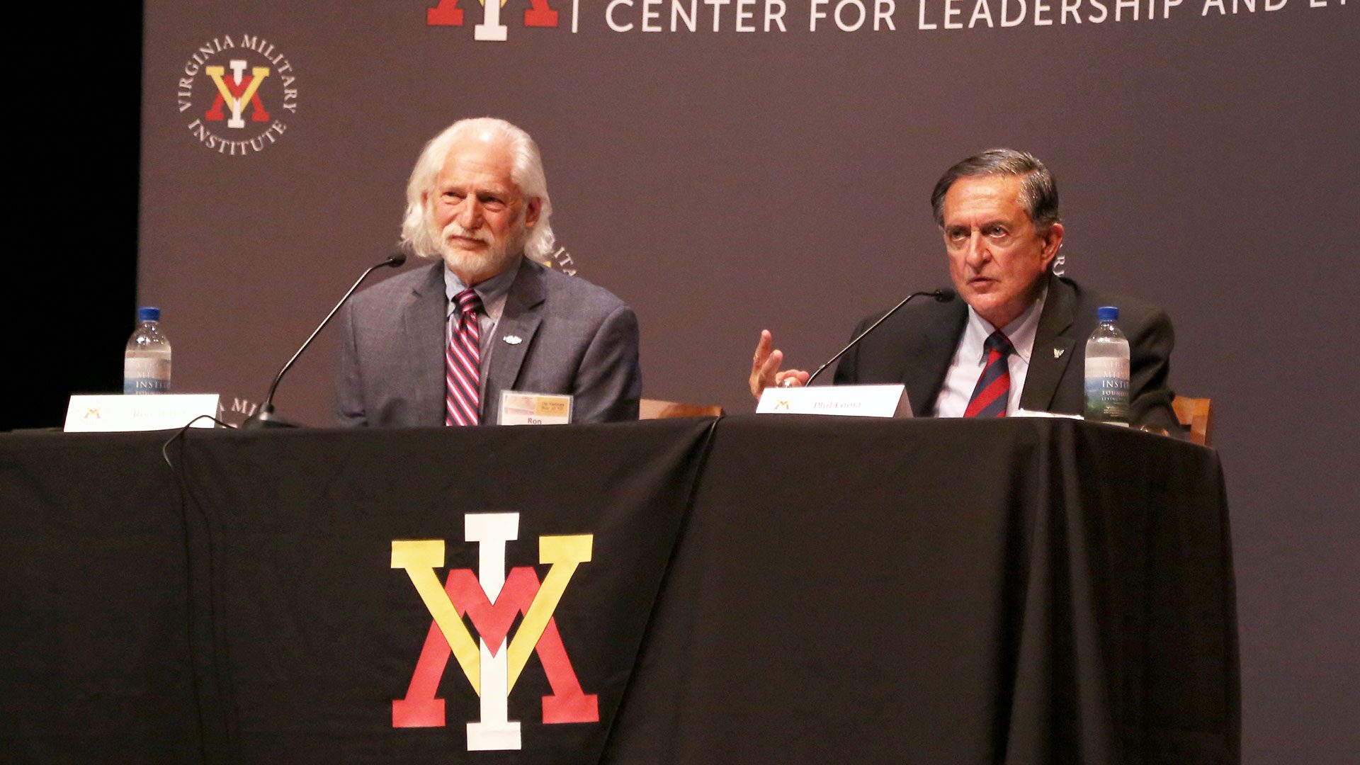 Ron Milam, Ph.D., left, and Phil Goia ’67 at a panel