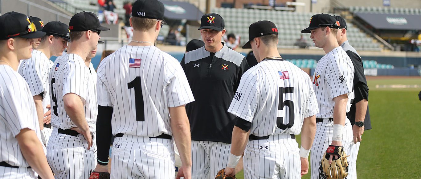 Jonathan Hadra ’04, head baseball coach, talks with his team. Photo by Chuck Steenburgh ’86.