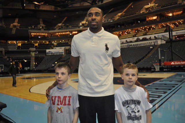 Charlotte chapter alumni at basketball game with 2 children