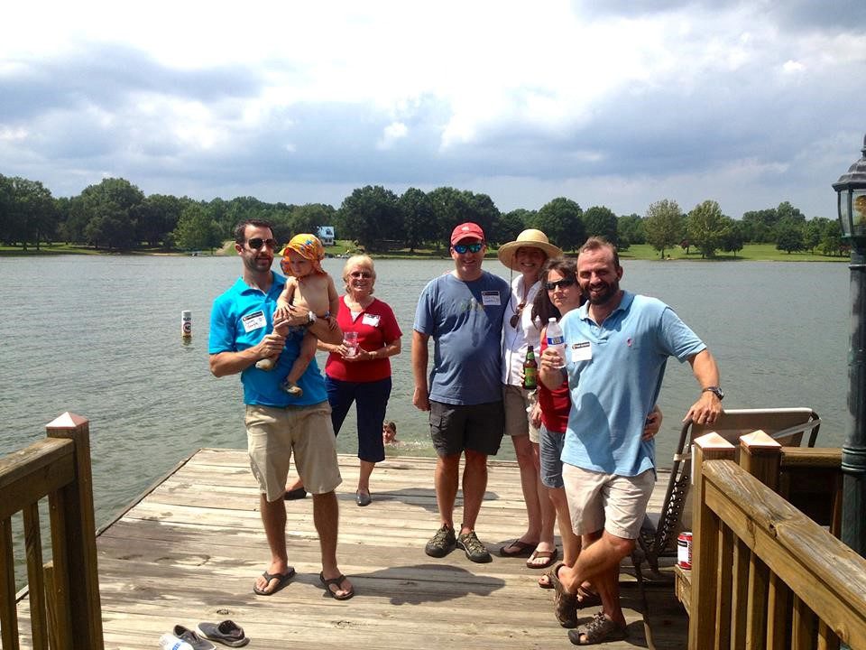 Charlotte chapter alumni standing on a dock by water