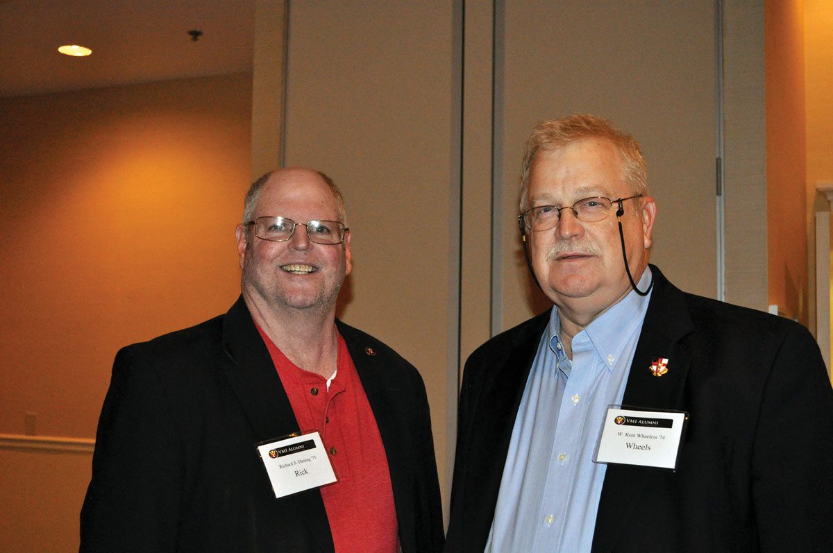 two Fayetteville alumni standing at event