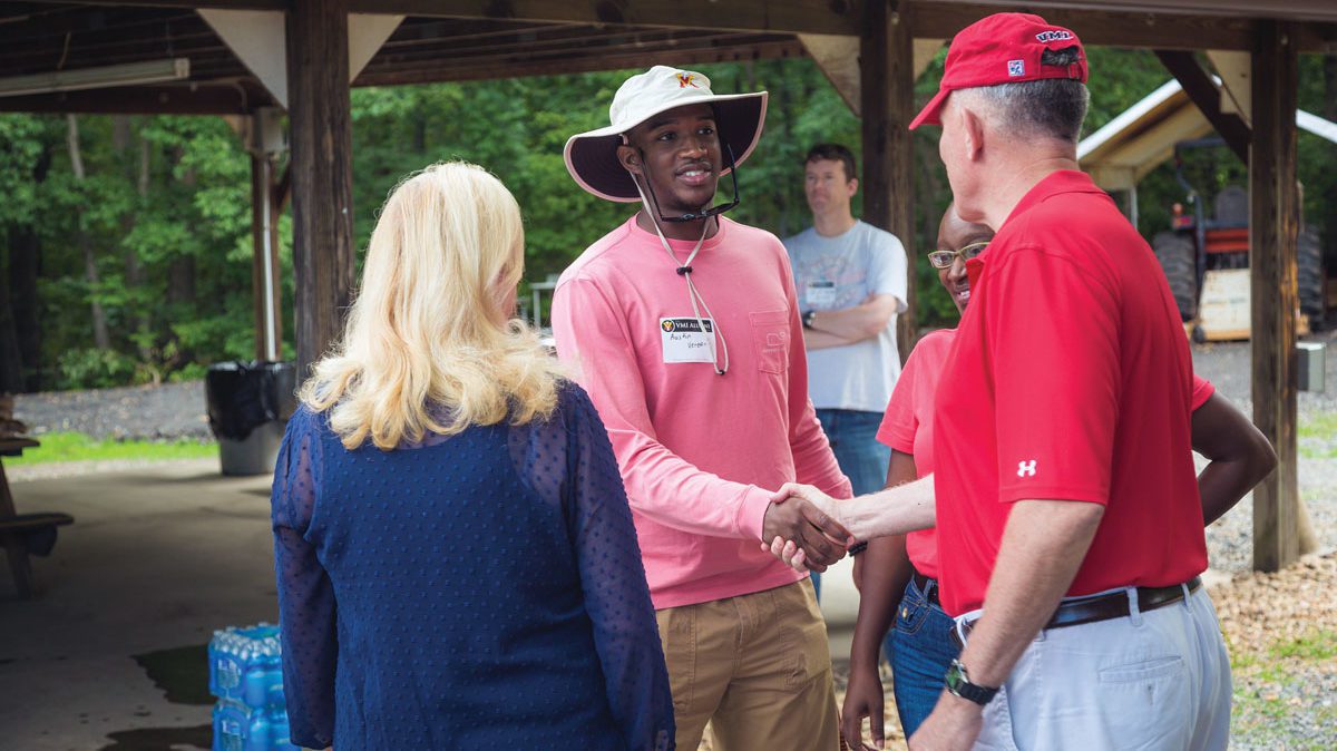 VMI alumni shaking hands at picnic