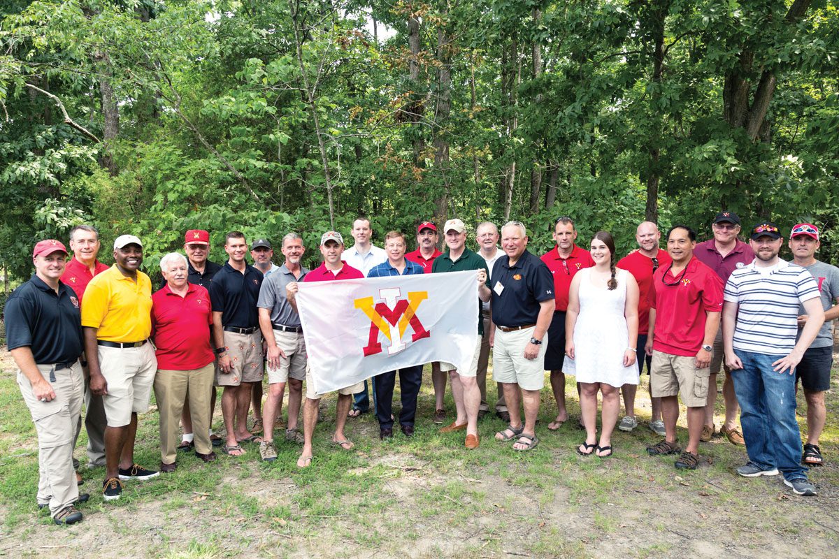 Alumni standing with VMI flag