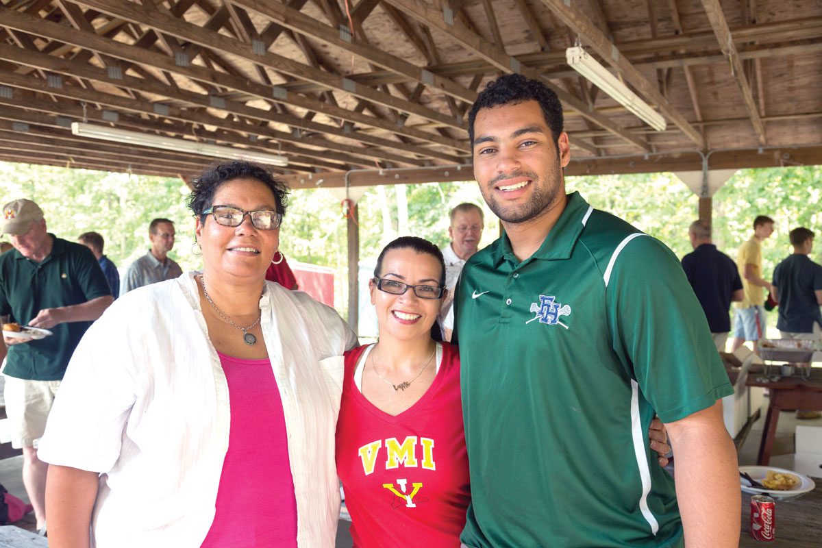 Alumni standing together at picnic shelter