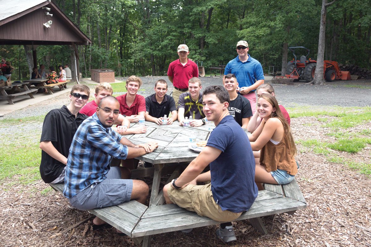 Alumni sitting around picnic table