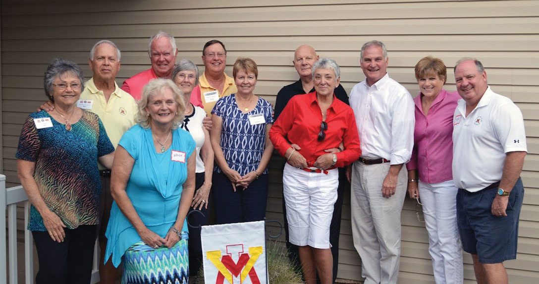 group of The Villages Florida standing with VMI flag