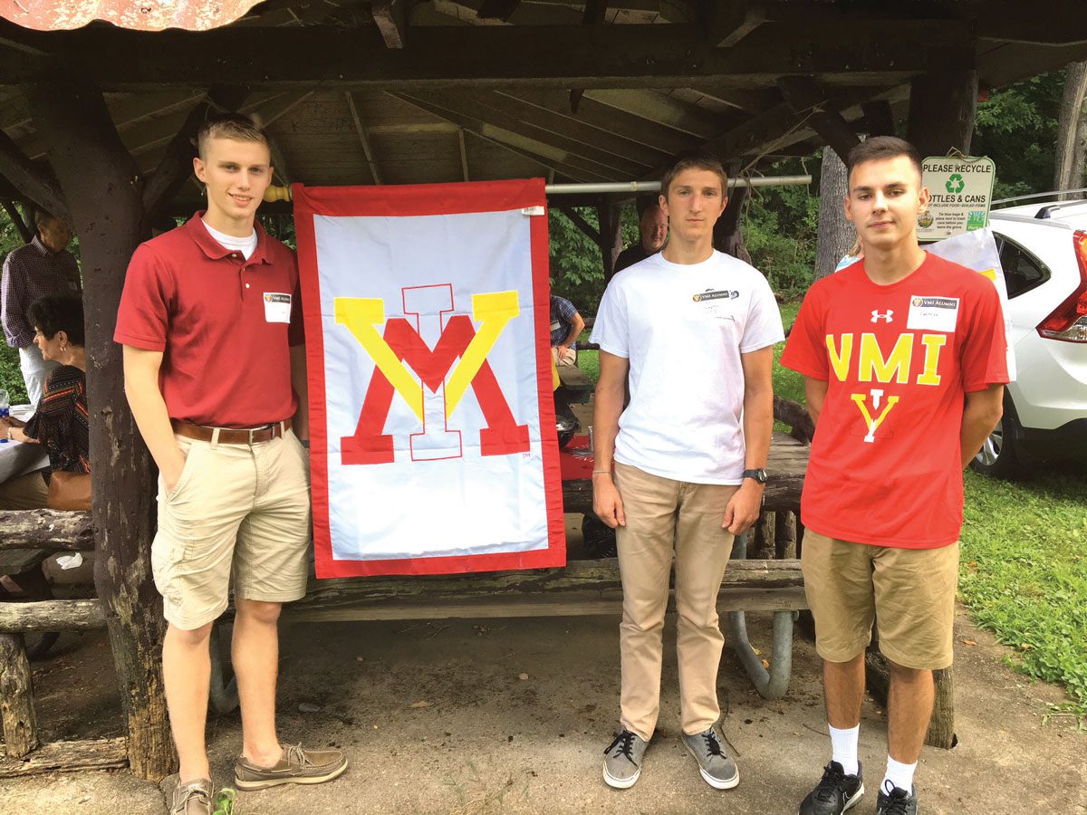 Pittsburg chapter alumni standing with VMI flag