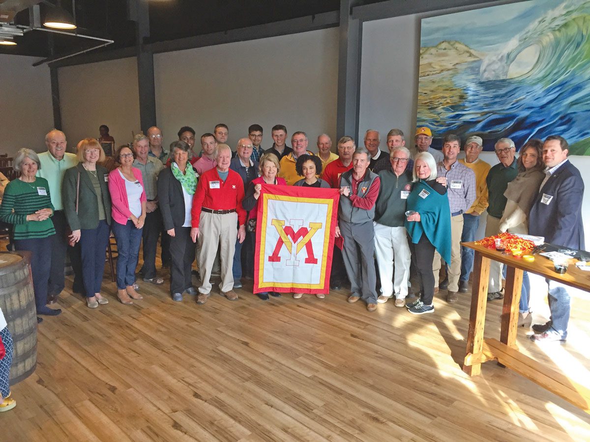 Wilmington Chapter alumni standing with VMI flag