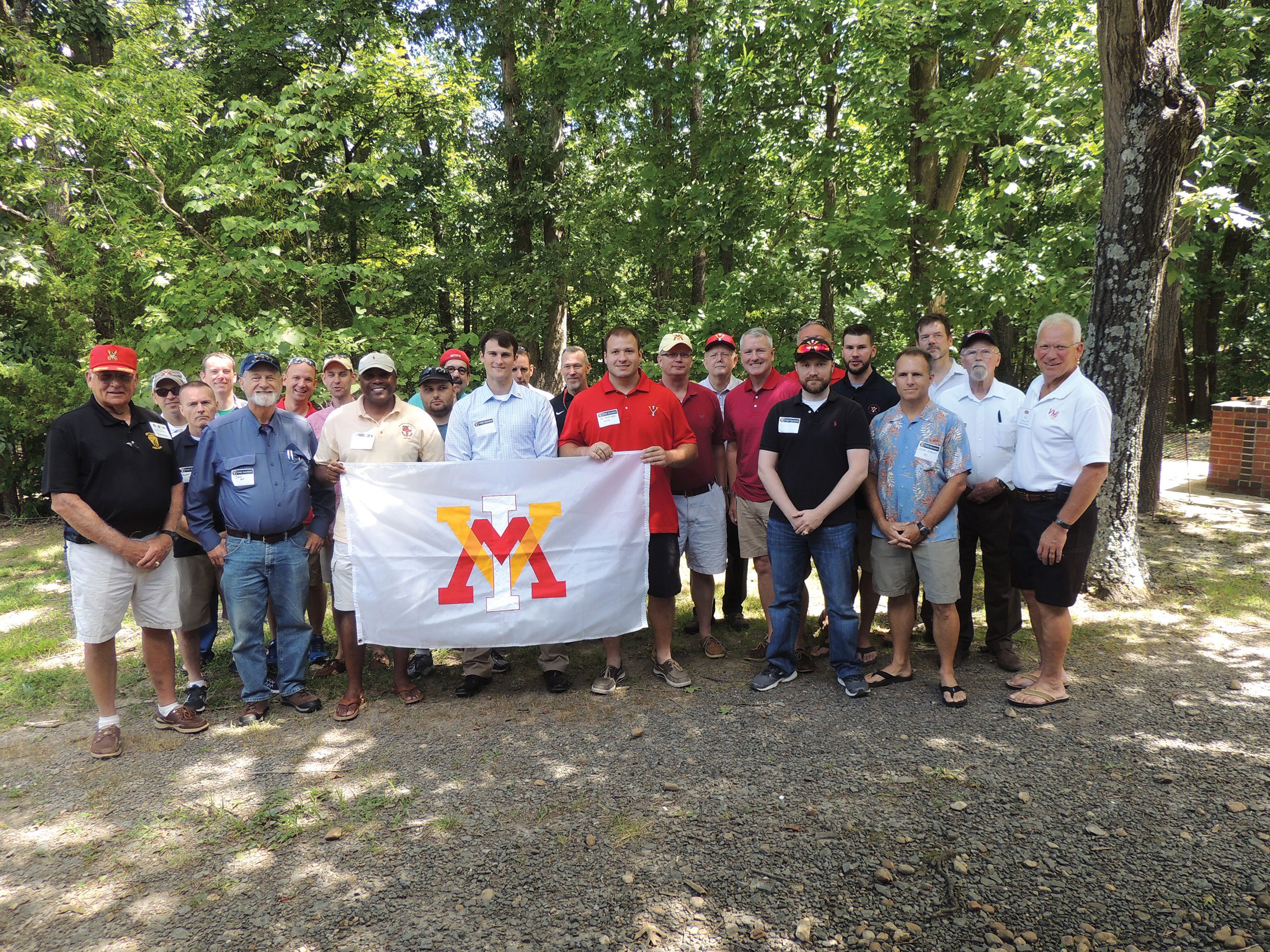 Group of alumni posing with VMI flag