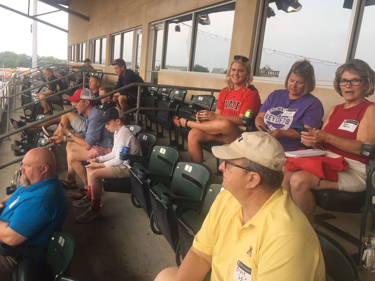 Upstate Pigsah chapter alumni sitting at baseball game