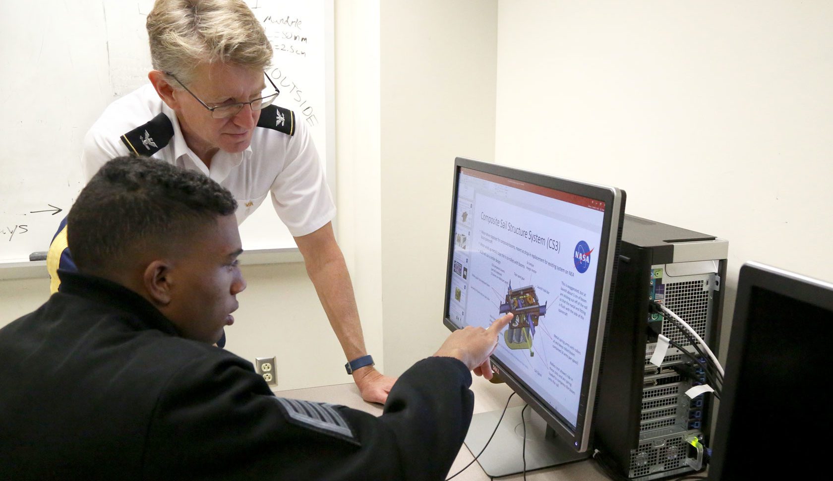 VMI Professor and student looking at computer screen