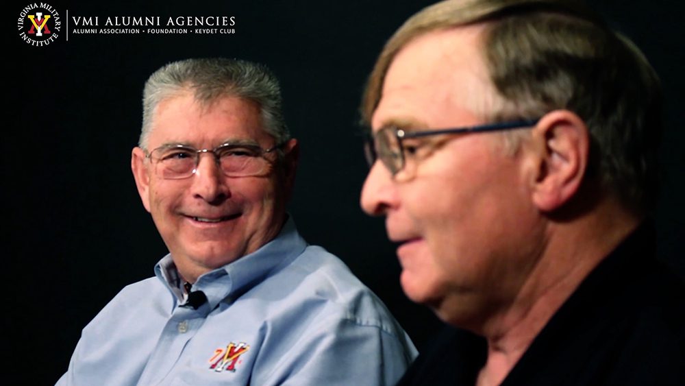 Mike Kelly '73 and Steve Kelly '77 mid-interview. They sit beside each other in front of a black background.