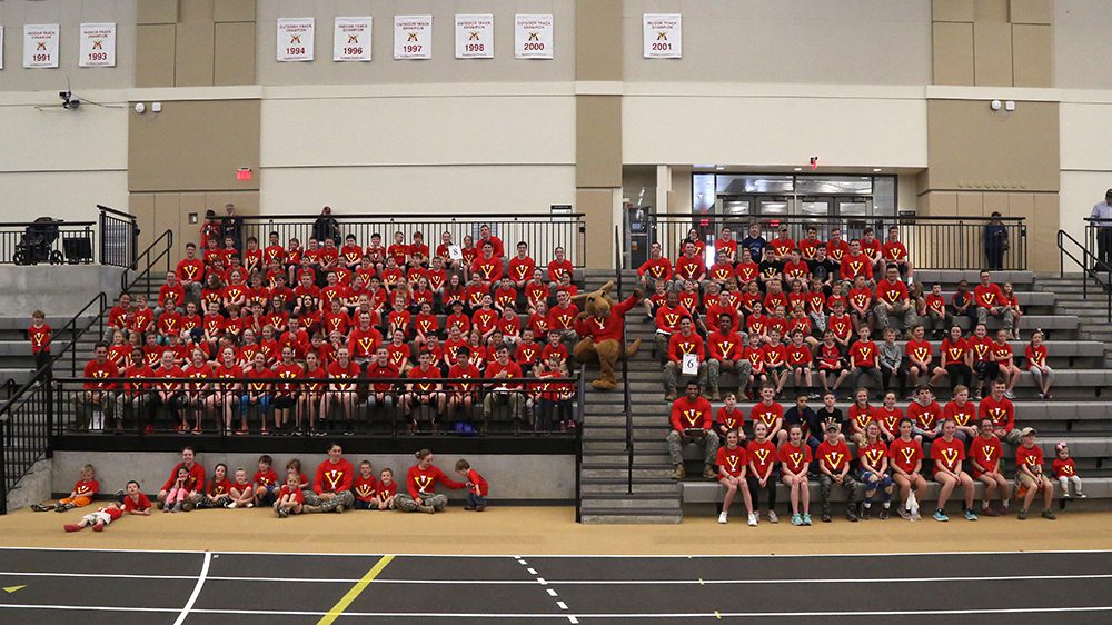 group of kids on bleachers in CPTF, smiling