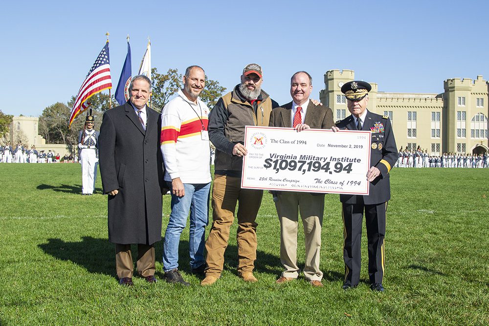 Members of the Class of 1994 pose with Steve Maconi and Gen. Peay, holding a check to the Institute on behalf of the Class of '94.