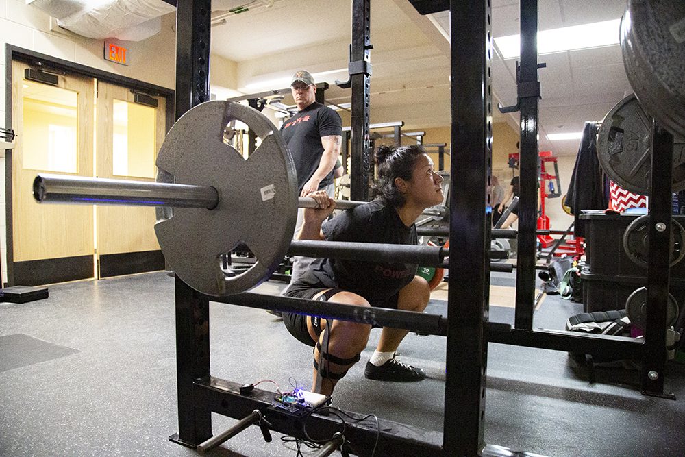 Annie Wilson '20 preparing to lift barbell