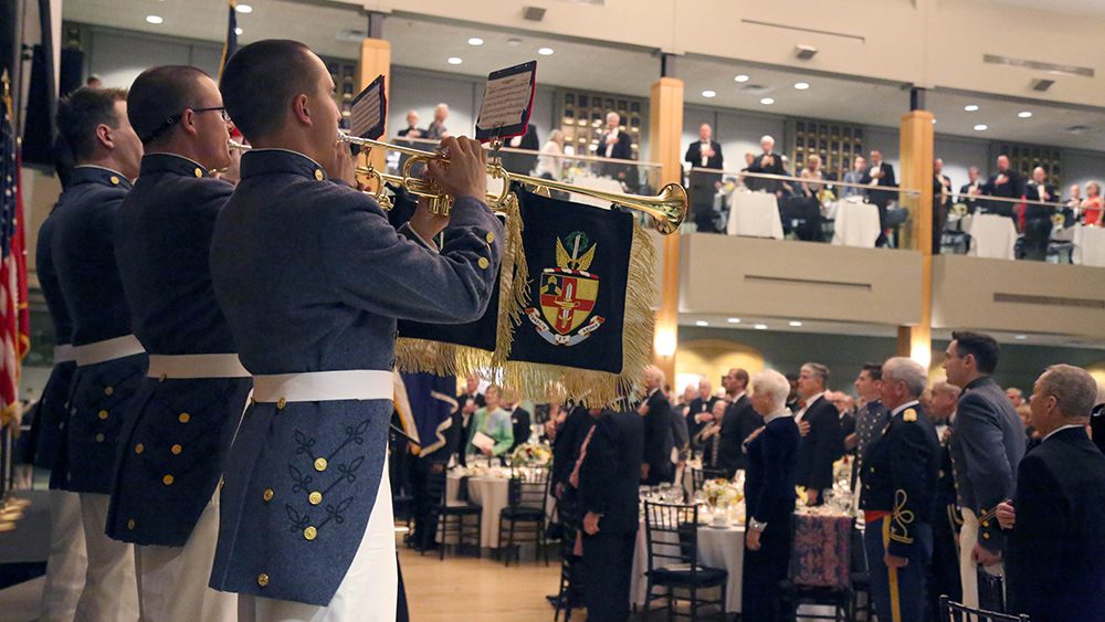 buglers playing music to a crowd in the Center for Leadership and Ethics/