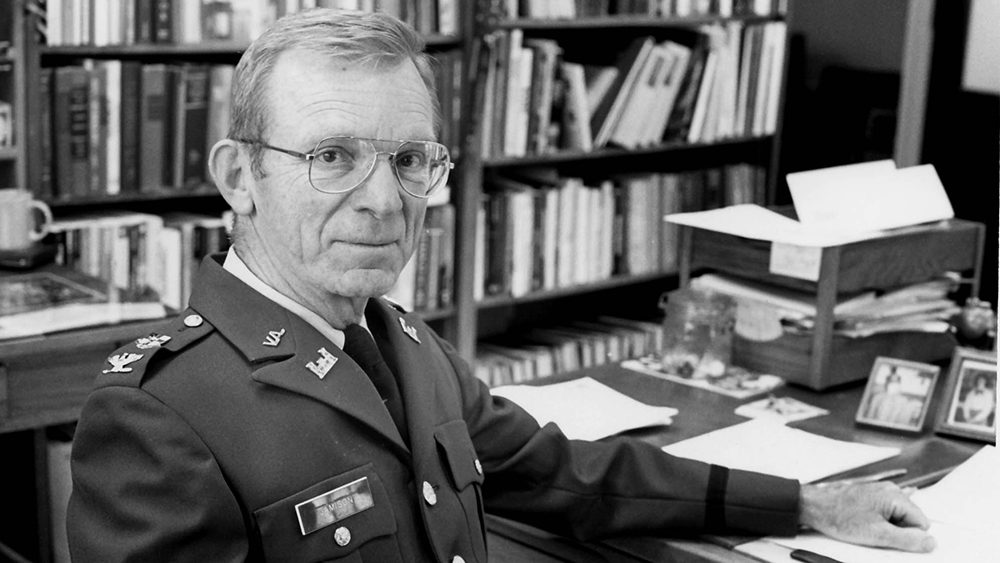 black and white photo of Donald K. Jamison '57 seated at a desk.