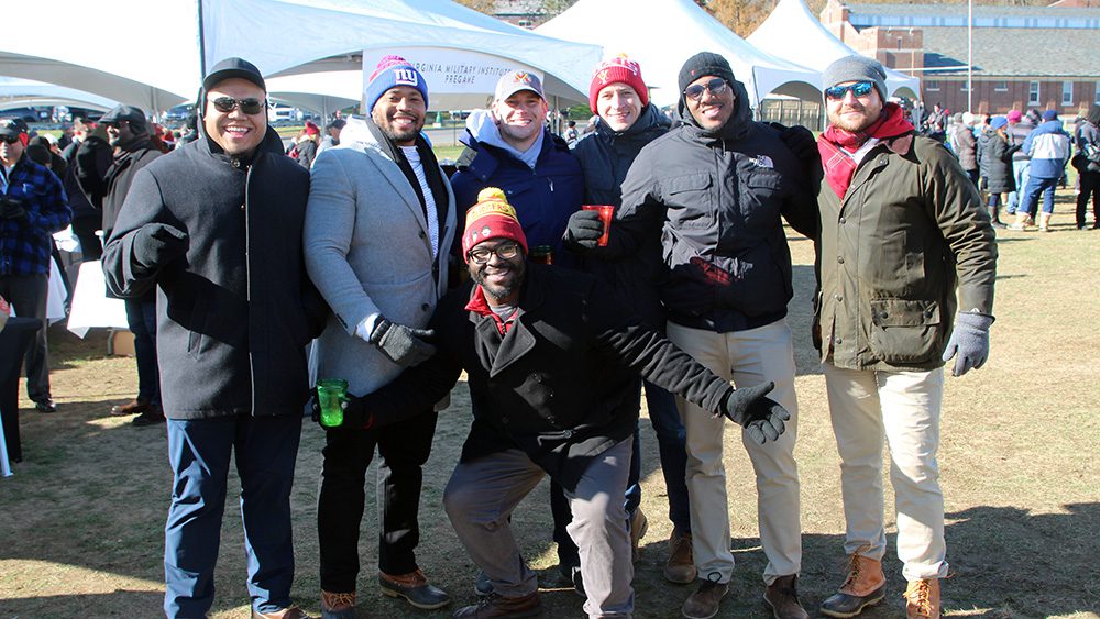 Seven people with arms around each other, smiling.