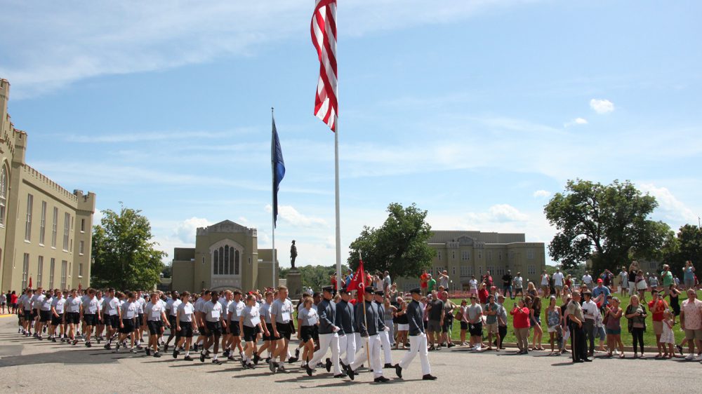 cadets and rats marching in front of barracks