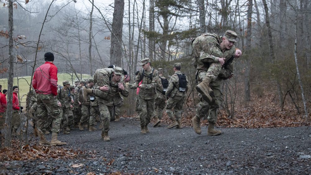cadets doing buddy carry up a hil