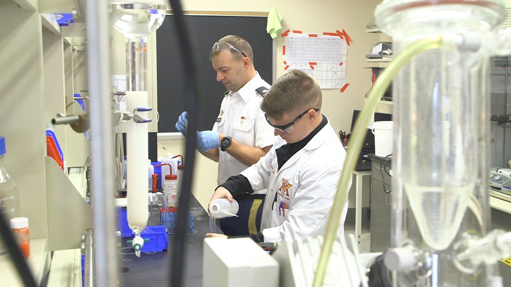 cadet and professor conduct lab experiment