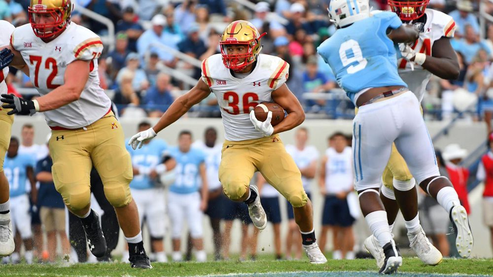 Football players on field during a game.