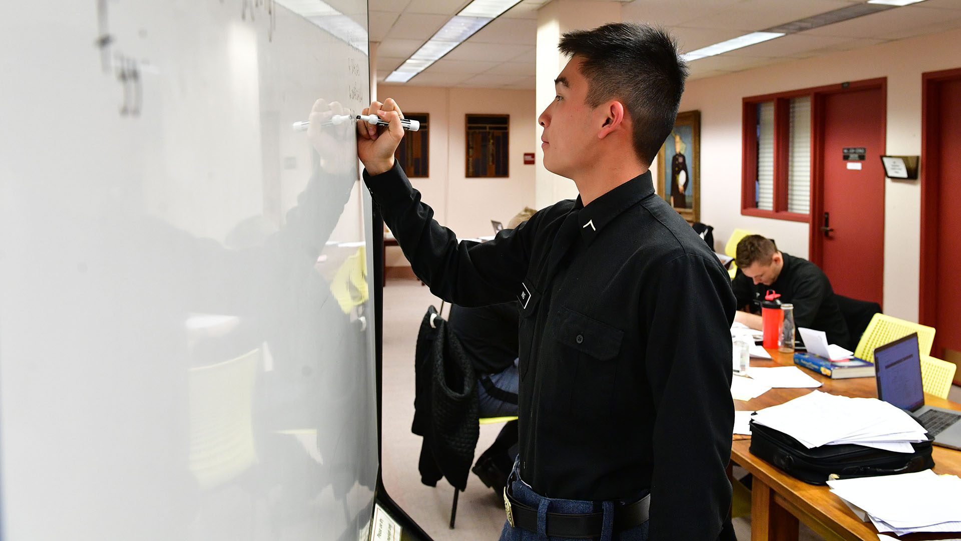 cadet writing on white board