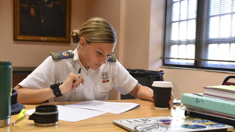 cadet at table doing classwork