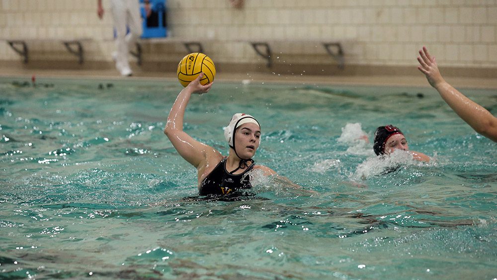 Water polo athlete preparing to throw ball.