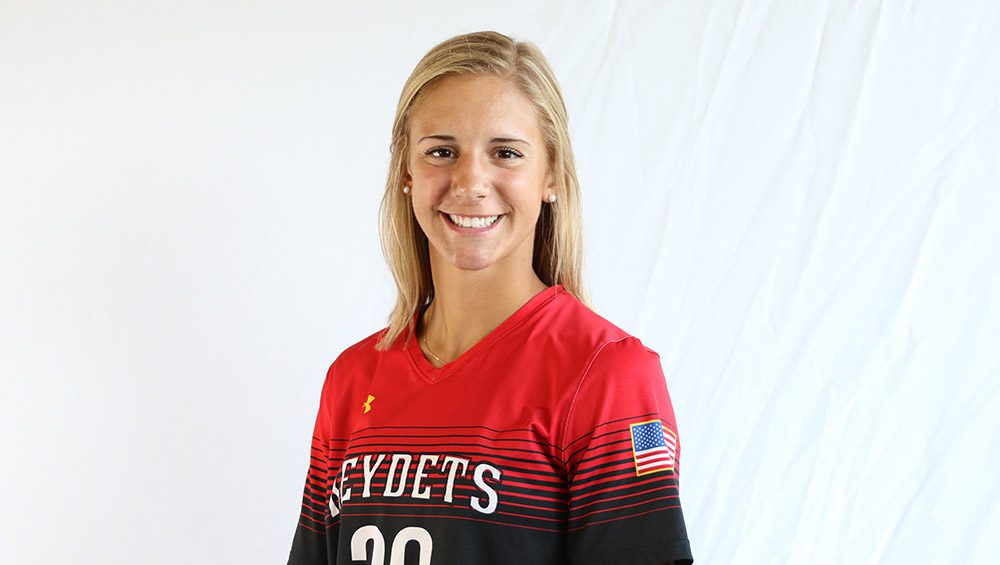 female soccer player in uniform, smiling