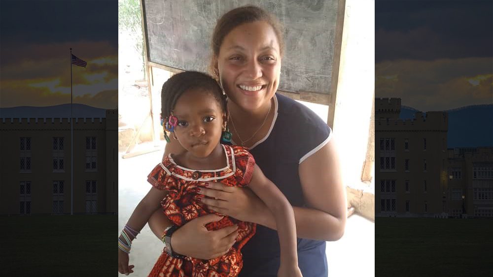 Woman holding child, smiling