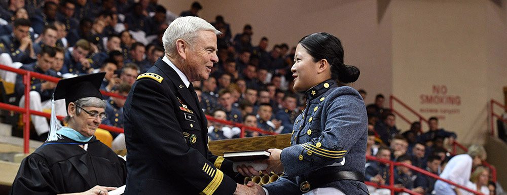 General Peay shaking hand with cadet and handing diploma