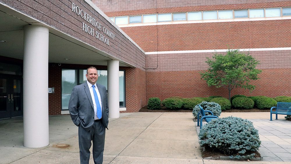 Man standing outside Rockbridge County High School, smiling