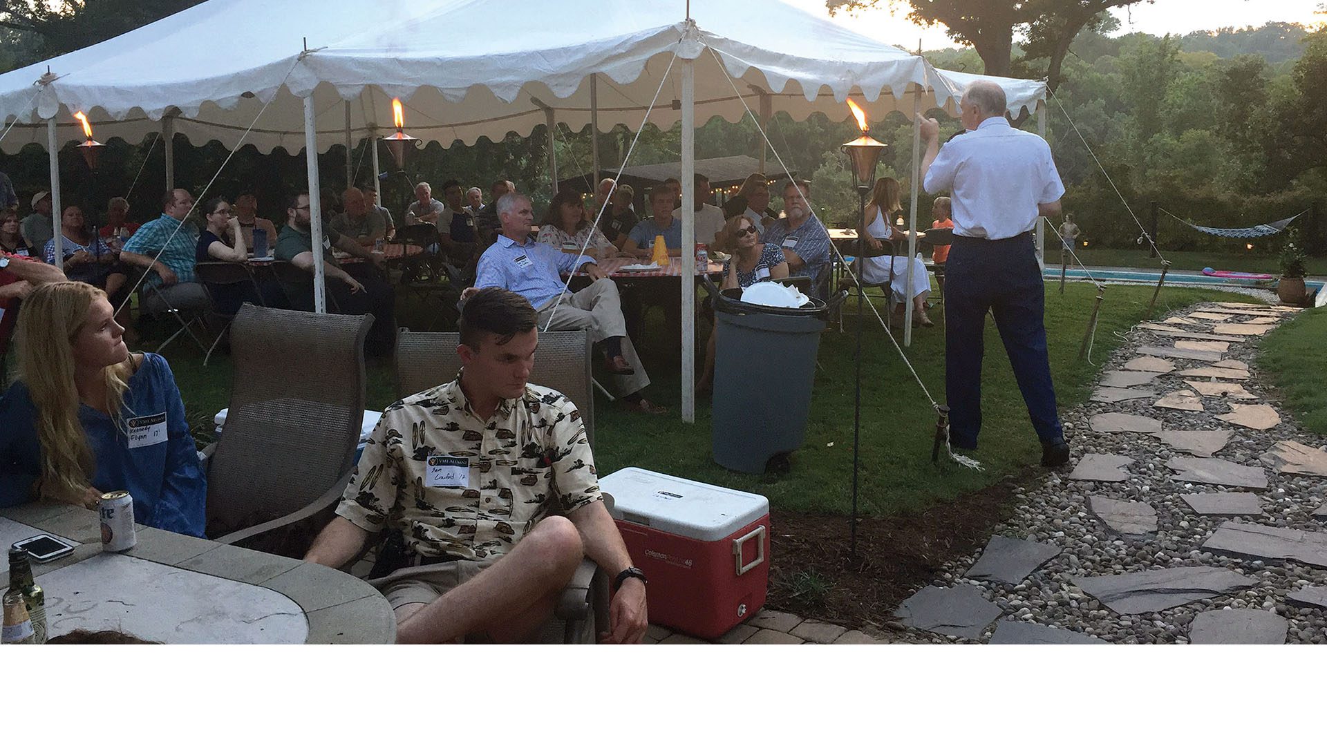 people seated under tent